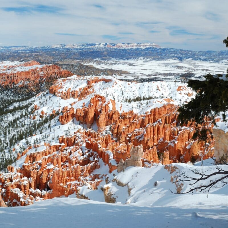 Bryce canyon panorama with snow in Winter with red rocks and blue sky.