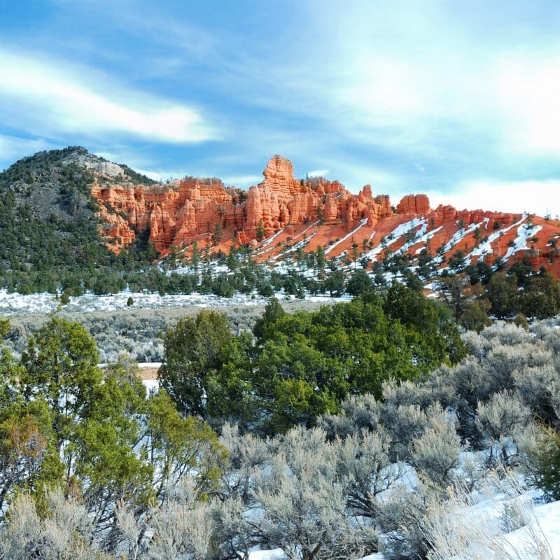 Red rocks in Bryce Canyon National Park with snow and trees in Utah.